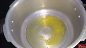 Add ghee in pressure cooker