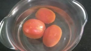 let the tomatoes soak in hot water so that the skin of tomatoes peel easily for the tomato soup