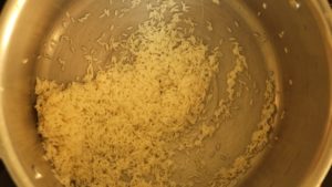 Take raw rice in a pressure cooker